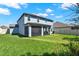 Expansive backyard with lush green grass, screened lanai and a well-maintained lawn at 11486 June Briar Loop, San Antonio, FL 33576