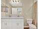 Bathroom featuring a double vanity with white cabinets, a large mirror and wood look flooring at 11486 June Briar Loop, San Antonio, FL 33576