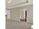 Empty bedroom with carpeted floors and access to other areas at 11486 June Briar Loop, San Antonio, FL 33576