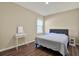 Cozy bedroom featuring a bed, vanity, and hardwood floors at 11486 June Briar Loop, San Antonio, FL 33576