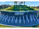 The Mirada community entrance has cascading water features, lush green landscaping, and the community name at 11486 June Briar Loop, San Antonio, FL 33576
