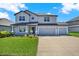 Charming two-story home with a three car garage, manicured lawn and a welcoming front porch at 11486 June Briar Loop, San Antonio, FL 33576