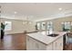 Open concept kitchen and living space with stainless steel appliances and hardwood floors at 11486 June Briar Loop, San Antonio, FL 33576