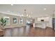 Spacious living and kitchen area with hardwood floors, recessed lighting, and access to the patio at 11486 June Briar Loop, San Antonio, FL 33576