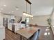 Open-concept kitchen, dining, and living area with stainless appliances and hardwood floors at 11486 June Briar Loop, San Antonio, FL 33576