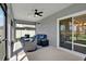Relaxing screened porch with a ceiling fan and stylish outdoor furniture at 11486 June Briar Loop, San Antonio, FL 33576
