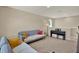 Comfortable sitting room with couches, an upright piano, and recessed lighting at 11486 June Briar Loop, San Antonio, FL 33576