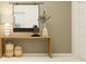 Entryway with a wooden table, decorative vases, stylish lamp, and a modern mirror at 11849 Blue Diamond Trl, Parrish, FL 34219