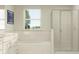 Clean bathroom featuring a tub, glass shower, and ample counter space, ideal for modern living at 11856 Blue Diamond Trl, Parrish, FL 34219