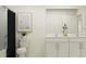 Bright bathroom featuring a double sink vanity with white cabinets and a shower with a dark curtain at 11856 Blue Diamond Trl, Parrish, FL 34219
