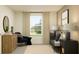 Bedroom featuring a white window, chair, dresser, crib and a decorative animal picture on the wall at 11856 Blue Diamond Trl, Parrish, FL 34219