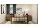 Bedroom with a metal bed frame, neutral-colored walls and carpet, nightstands, and matching lamps at 11856 Blue Diamond Trl, Parrish, FL 34219