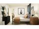 Bedroom with a metal bed frame, neutral-colored walls and carpet, nightstands, and decorative plant at 11856 Blue Diamond Trl, Parrish, FL 34219