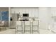Bright kitchen with white cabinets, stainless steel appliances, and counter seating at 11856 Blue Diamond Trl, Parrish, FL 34219