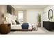 Serene primary bedroom featuring a king bed, bedside tables, and a contemporary dresser at 11856 Blue Diamond Trl, Parrish, FL 34219