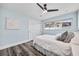 Light and airy bedroom with wood floors, a ceiling fan, and a window view of the neighborhood at 1281 St Andrews Dr, Dunedin, FL 34698