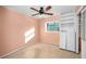 Cozy bedroom featuring a ceiling fan, window, and built-in shelving, offering comfort and practicality at 1361 Byron Dr, Clearwater, FL 33756