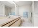 Bathroom includes a vanity with a sink, mirror, and a shower with a sliding glass door at 1728 Golfview Dr # 1728, Tarpon Springs, FL 34689