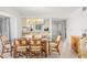 Bright dining area features a glass top table with seating for six with views into the kitchen at 1728 Golfview Dr # 1728, Tarpon Springs, FL 34689