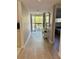 Bright hallway featuring wood-look tile flooring, a balcony, and decoratively painted walls at 1728 Golfview Dr # 1728, Tarpon Springs, FL 34689