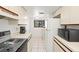 Kitchen featuring white cabinets, tile floors, and modern appliances creating a clean and functional cooking space at 1728 Golfview Dr # 1728, Tarpon Springs, FL 34689