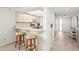 Open kitchen area with breakfast bar seating, connecting seamlessly to the entryway and other living spaces at 1728 Golfview Dr # 1728, Tarpon Springs, FL 34689
