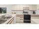 Well-lit kitchen with ample counter space, white cabinets, and all appliances, perfect for cooking at 1728 Golfview Dr # 1728, Tarpon Springs, FL 34689