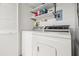 Functional laundry room featuring a side-by-side washer and dryer and storage at 1728 Golfview Dr # 1728, Tarpon Springs, FL 34689