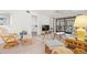 Cozy living room with stylish furnishings, view of the bedroom, and a sliding glass door to the balcony at 1728 Golfview Dr # 1728, Tarpon Springs, FL 34689