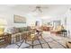 Open-concept living room flows into the dining area, creating a spacious and inviting atmosphere with bright natural lighting at 1728 Golfview Dr # 1728, Tarpon Springs, FL 34689