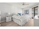 Bright bedroom boasts a large bed, nightstands, and access to a screened in lanai at 1728 Golfview Dr # 1728, Tarpon Springs, FL 34689