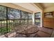Relax on this screened patio with table seating and outdoor views of the surrounding green space at 1728 Golfview Dr # 1728, Tarpon Springs, FL 34689