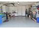 Organized garage featuring a clean epoxy floor, ample storage cabinets, and workspace at 1746 Ravenridge St, Wesley Chapel, FL 33543