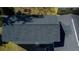 Overhead aerial view focusing on the home's roof, gutters, and backyard patio with furniture at 210 83Rd N Ave, St Petersburg, FL 33702