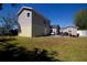 Spacious backyard with a patio area, featuring a mix of grass and bare areas at 210 83Rd N Ave, St Petersburg, FL 33702