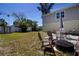 Spacious backyard with outdoor seating area, grassy space, and storage shed, perfect for relaxing and entertaining at 210 83Rd N Ave, St Petersburg, FL 33702