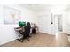 Bedroom with wood-look floors, modern art, and a view to the ensuite bathroom at 210 83Rd N Ave, St Petersburg, FL 33702