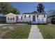 Cozy single-story home with a covered front porch and charming curb appeal at 210 83Rd N Ave, St Petersburg, FL 33702
