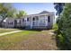 Inviting single-story home features a cozy front porch with classic white railings at 210 83Rd N Ave, St Petersburg, FL 33702