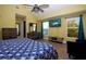 Bright, spacious main bedroom featuring wood-look floors, vaulted ceilings, TV, and generous closet space at 210 83Rd N Ave, St Petersburg, FL 33702