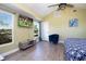Bright, spacious main bedroom featuring wood-look floors, vaulted ceilings, TV, and generous closet space at 210 83Rd N Ave, St Petersburg, FL 33702