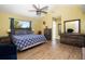 Bright, spacious main bedroom featuring wood-look floors, vaulted ceilings, and generous closet space at 210 83Rd N Ave, St Petersburg, FL 33702