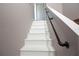 Stairway featuring white stairs and black iron handrail for added safety at 210 83Rd N Ave, St Petersburg, FL 33702