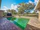 A large brick pool deck surrounds a refreshing in-ground pool in the backyard at 3100 Masters Dr, Clearwater, FL 33761