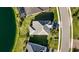 Aerial shot showcases a well-maintained roof and landscaping near a tranquil lake, with neighborhood street at 3248 Anchor Bay Trl, Bradenton, FL 34211