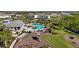 Aerial view of community pool, clubhouse, and playground surrounded by lush landscaping and trees at 3248 Anchor Bay Trl, Bradenton, FL 34211