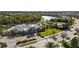 A lovely aerial view of the community pool and clubhouse with palm trees and lush green surroundings at 3248 Anchor Bay Trl, Bradenton, FL 34211