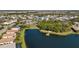 Gorgeous aerial view of a community pond, playground, and clubhouse surrounded by lush trees at 3248 Anchor Bay Trl, Bradenton, FL 34211