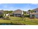 Backyard view with a fenced yard, palms, and lake, offering a peaceful outdoor setting at 3248 Anchor Bay Trl, Bradenton, FL 34211