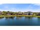 Waterfront backyard with palm trees and well maintained landscaping showcasing the tranquil setting at 3248 Anchor Bay Trl, Bradenton, FL 34211